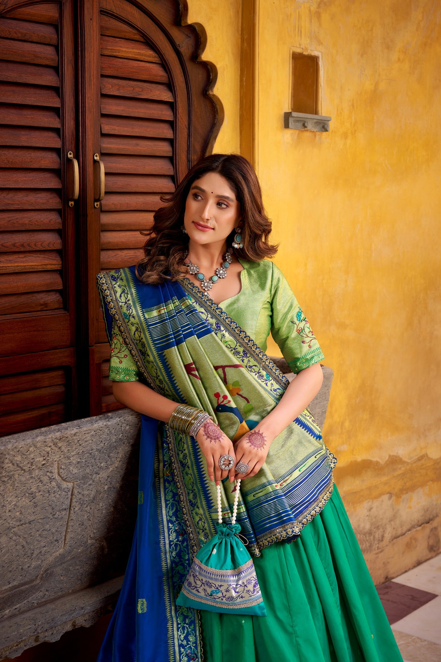 Draped in refreshing shades of green, this soft silk lehenga choli shines with intricate zari weaving, delicate sequins, thread embroidery, and an elegant scallop lace border 🍃✨