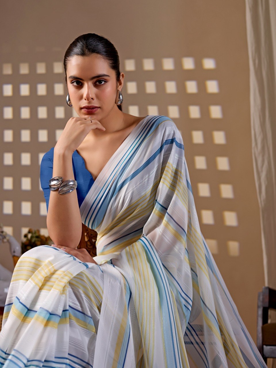 Premium Monsoon Saree featuring a soothing white base enhanced with elegant blue and yellow stripe patterns of saree