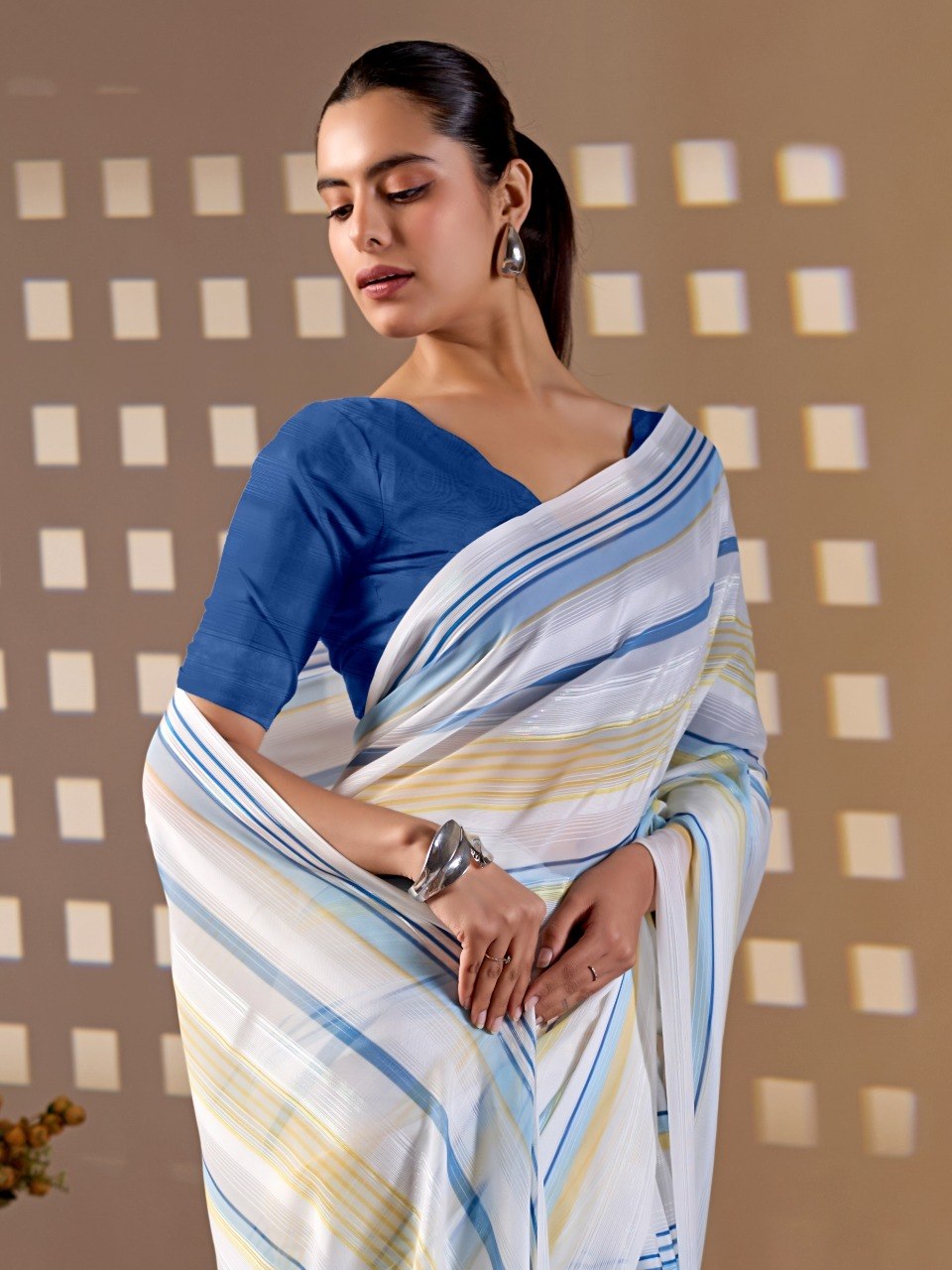 Premium Monsoon Saree featuring a soothing white base enhanced with elegant blue and yellow stripe patterns of saree