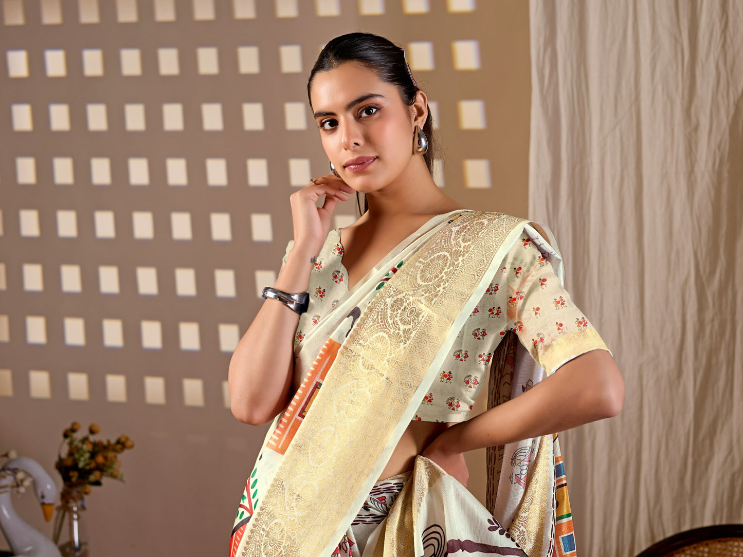 Soft Lichi Silk Saree with elegant traditional village art print in soothing cream shades and a rich woven border