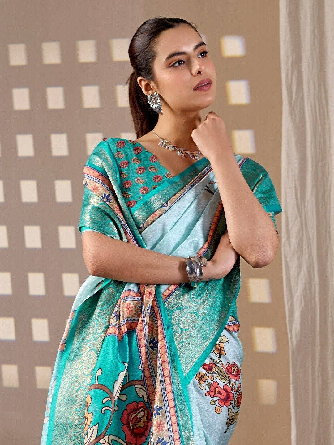 Soft Lichi Silk Saree with elegant floral print in soothing sky blue shades and a rich woven border
