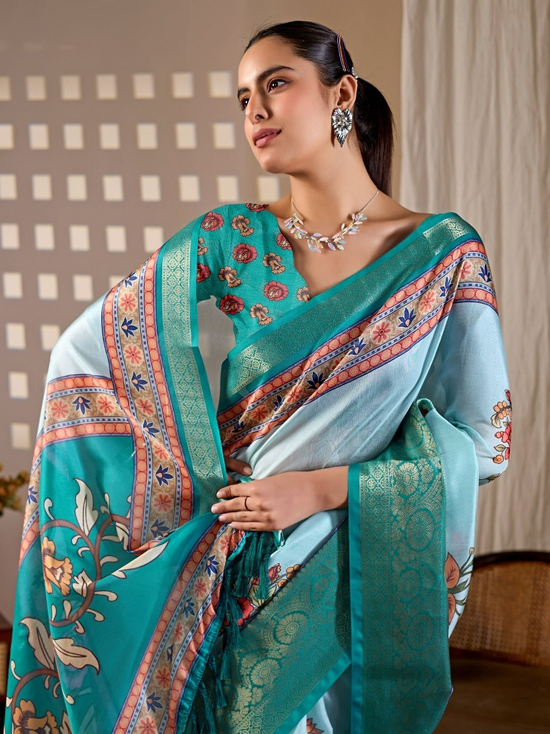 Soft Lichi Silk Saree with elegant floral print in soothing sky blue shades and a rich woven border