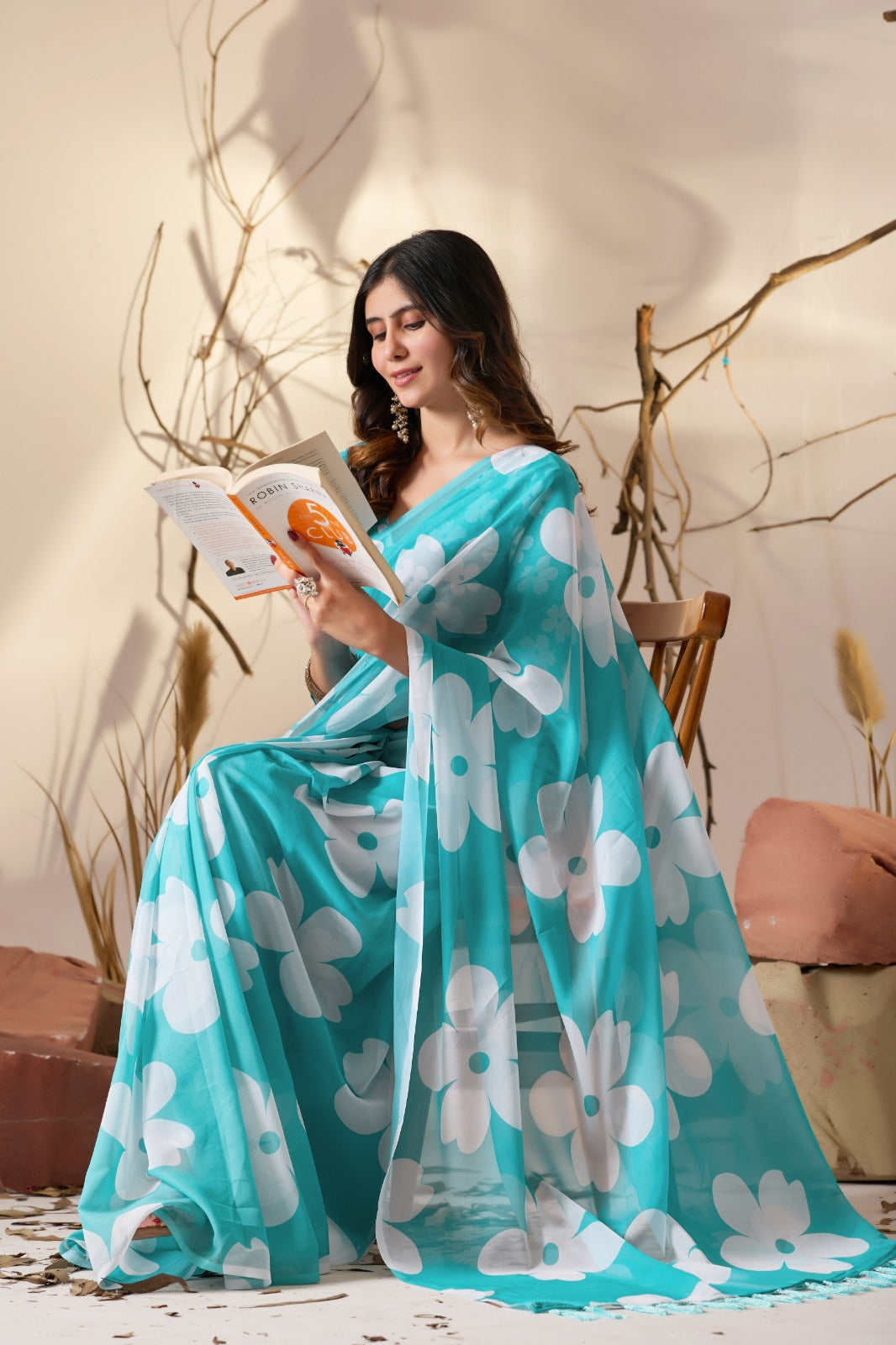 Vibrant Turquoise Blue Georgette Saree with Oversized White Floral Prints and Tassel Borders