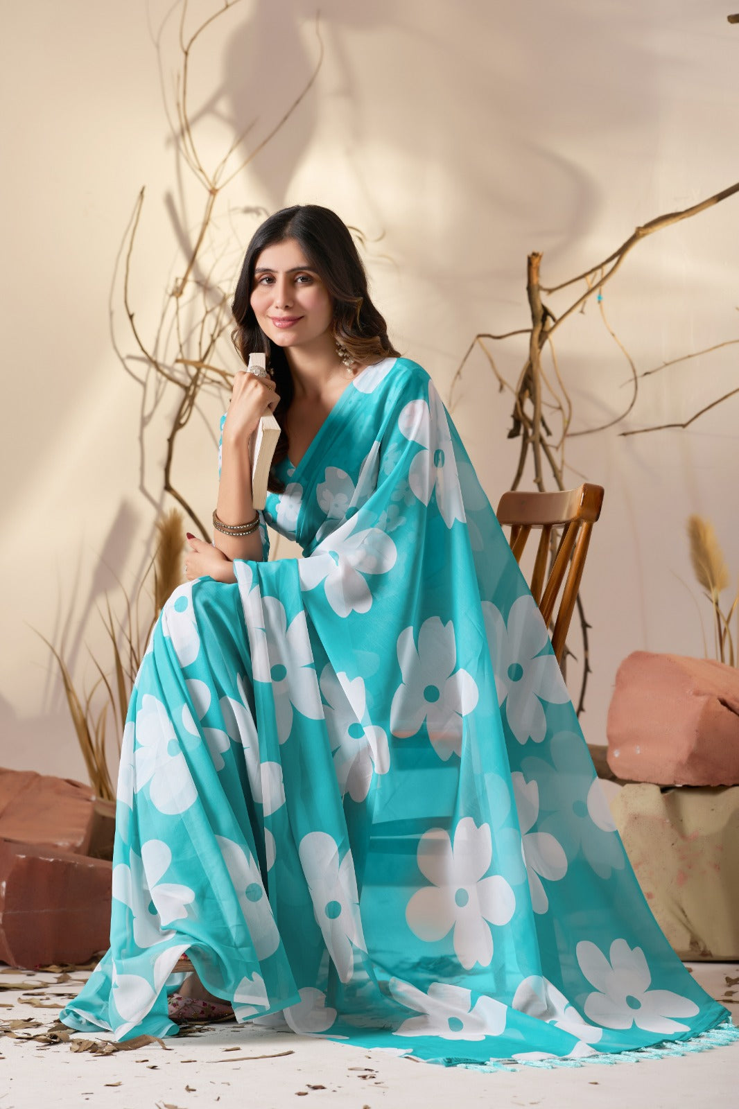 Vibrant Turquoise Blue Georgette Saree with Oversized White Floral Prints and Tassel Borders
