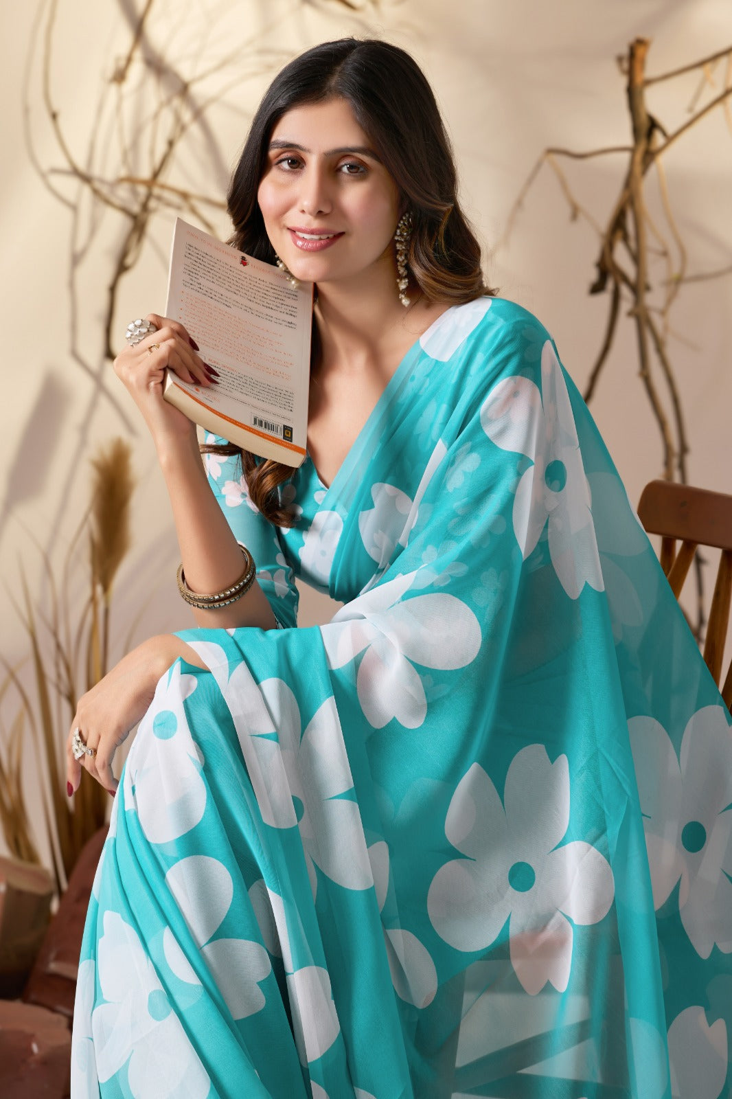 Vibrant Turquoise Blue Georgette Saree with Oversized White Floral Prints and Tassel Borders
