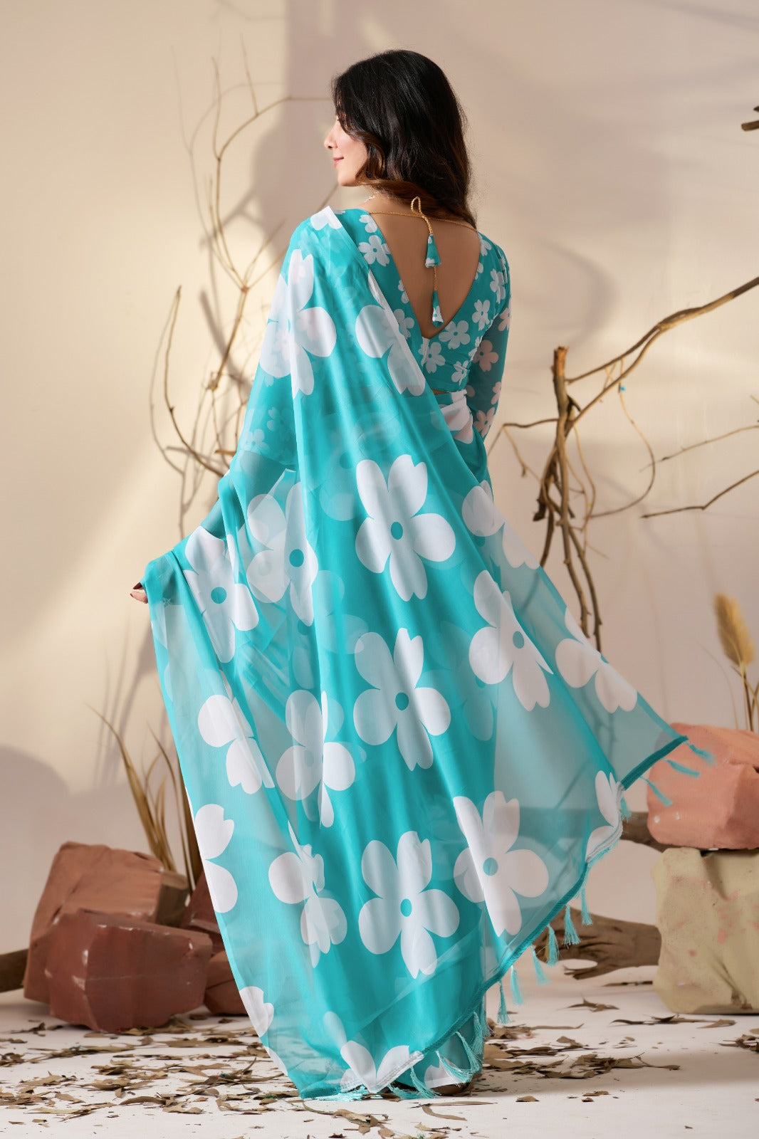 Vibrant Turquoise Blue Georgette Saree with Oversized White Floral Prints and Tassel Borders