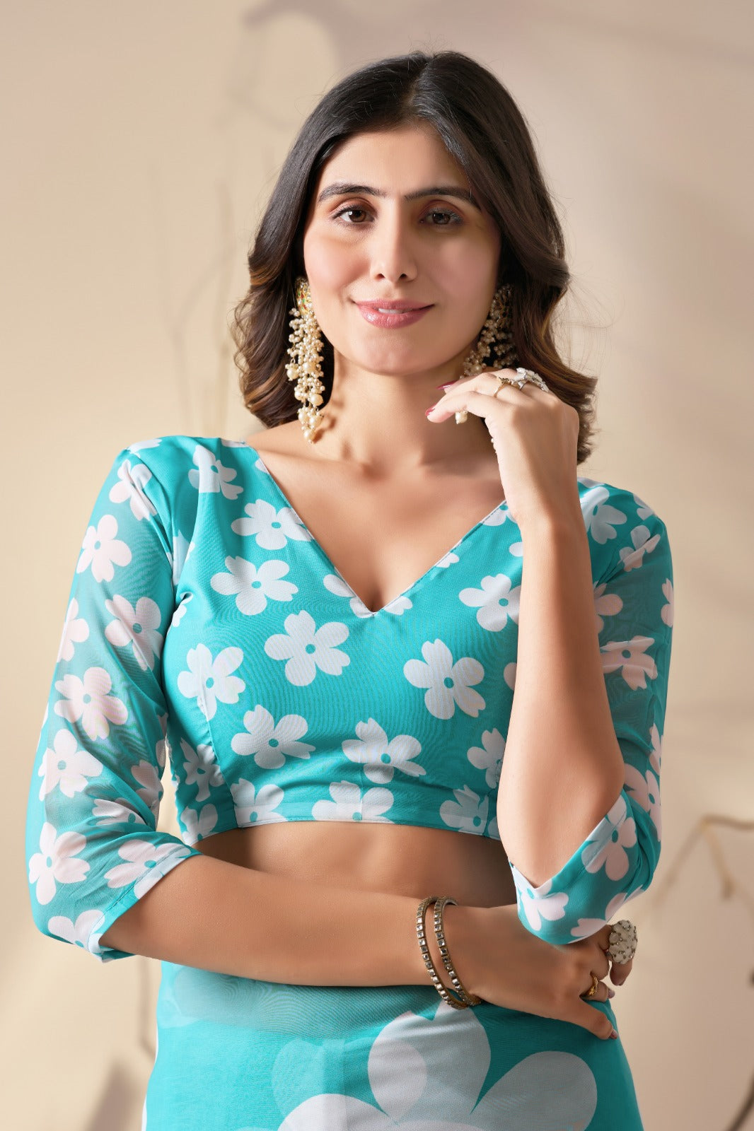 Vibrant Turquoise Blue Georgette Saree with Oversized White Floral Prints and Tassel Borders