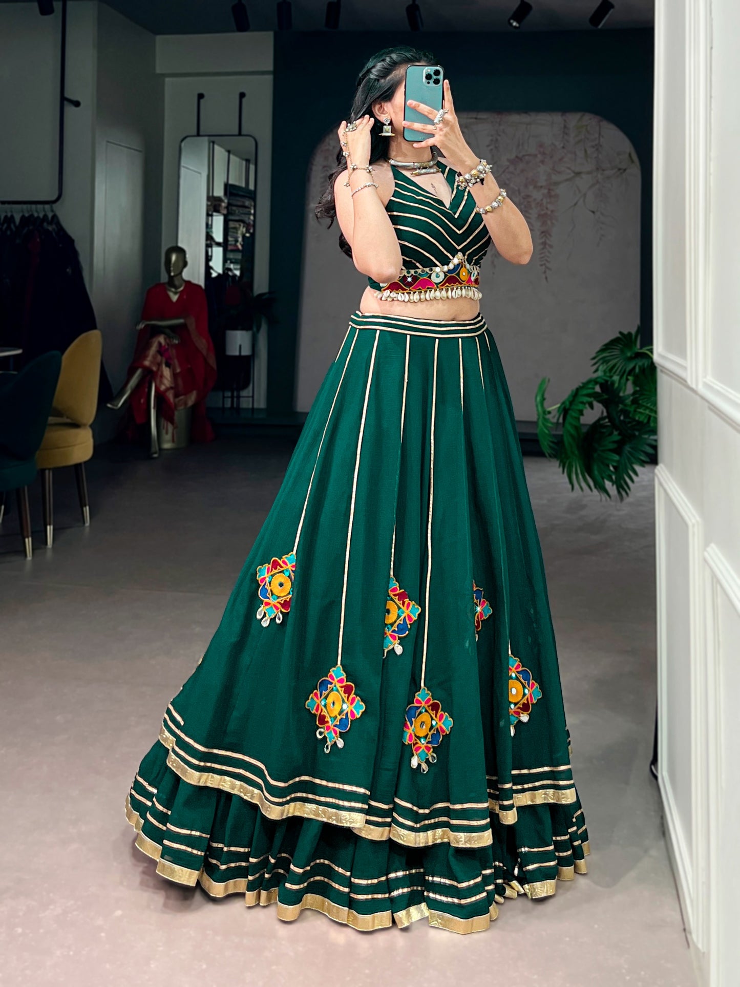 Lightweight fabric with vibrant Gamthi work, mirror detailing, Gotta Patti lace, and shell embellishments