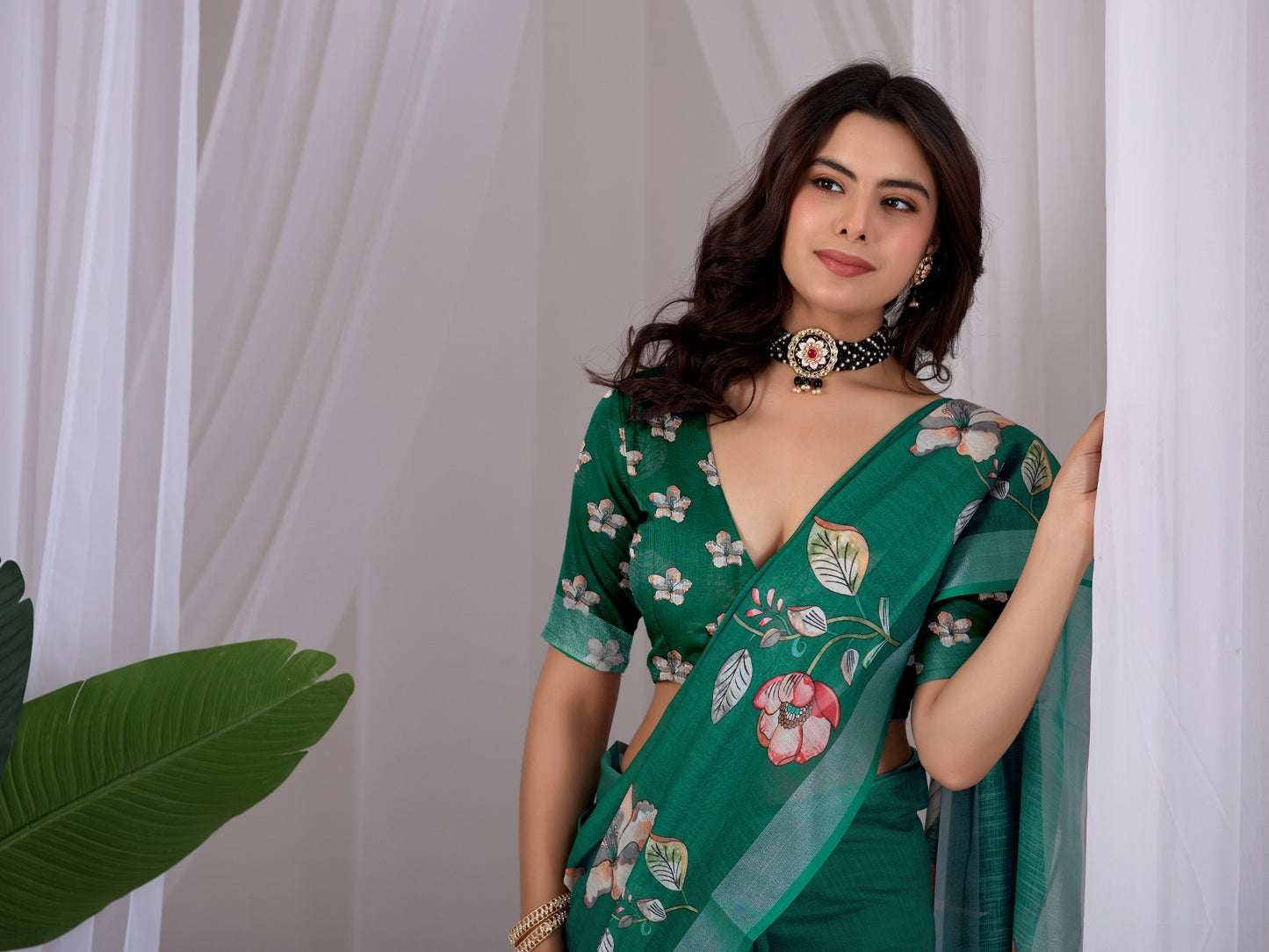 Elegant Emerald Green Festive Saree with Soft Peach and White Floral Accents and Pallu Tassels
