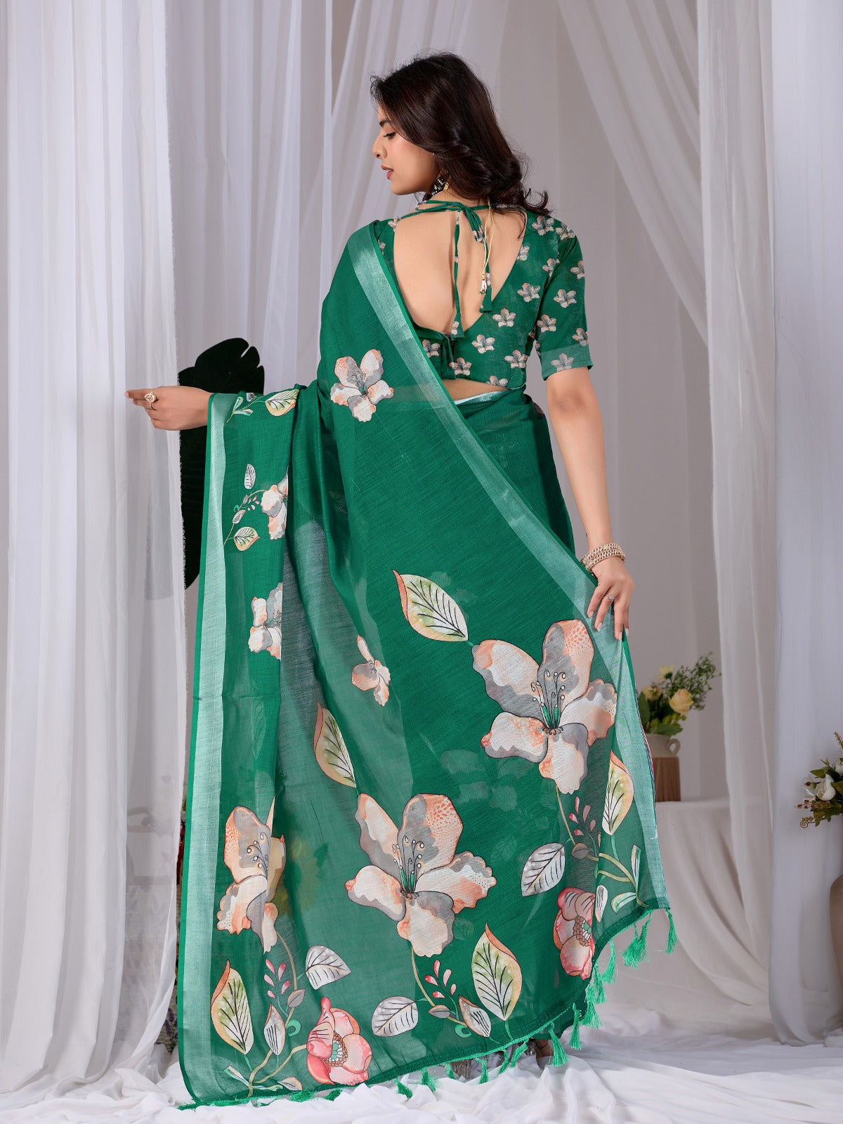Elegant Emerald Green Festive Saree with Soft Peach and White Floral Accents and Pallu Tassels