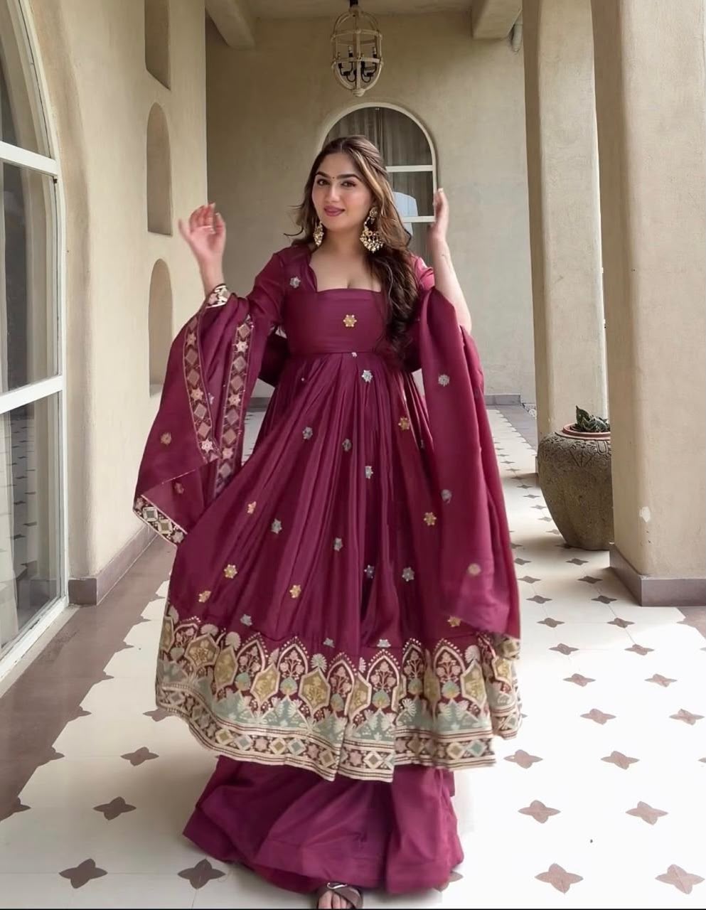 A Contemporary Interpretation of Traditional Royal Anarkali Silhouettes Against Minimalist Arched Architecture