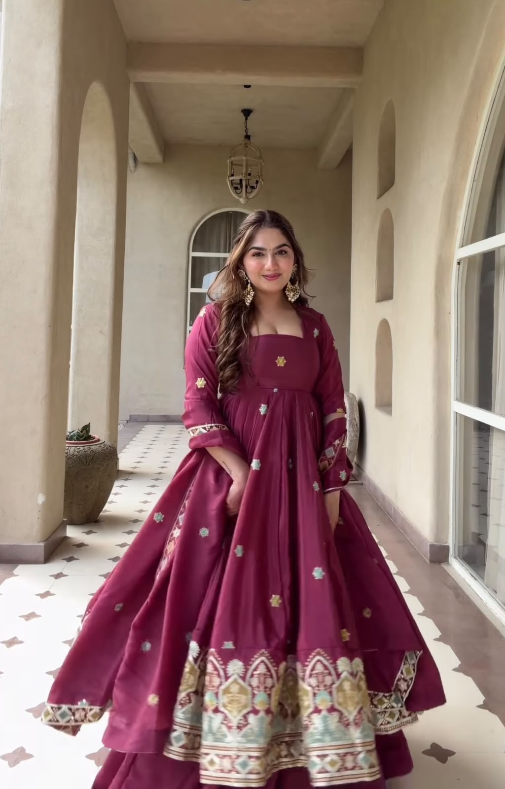 A Contemporary Interpretation of Traditional Royal Anarkali Silhouettes Against Minimalist Arched Architecture