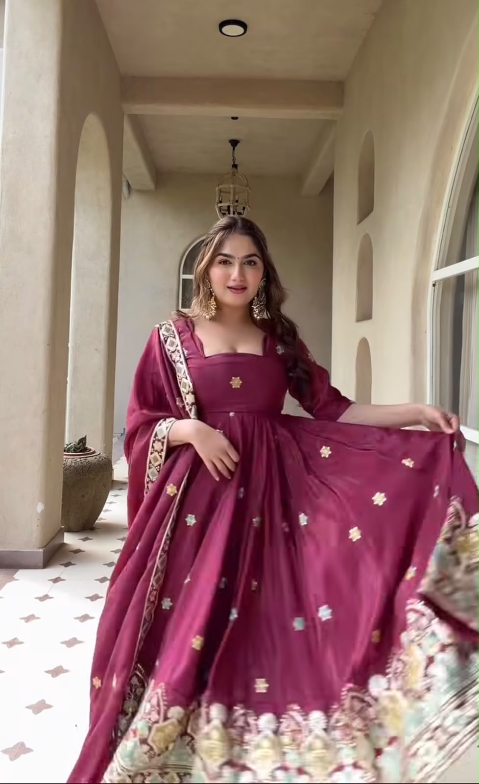 A Contemporary Interpretation of Traditional Royal Anarkali Silhouettes Against Minimalist Arched Architecture
