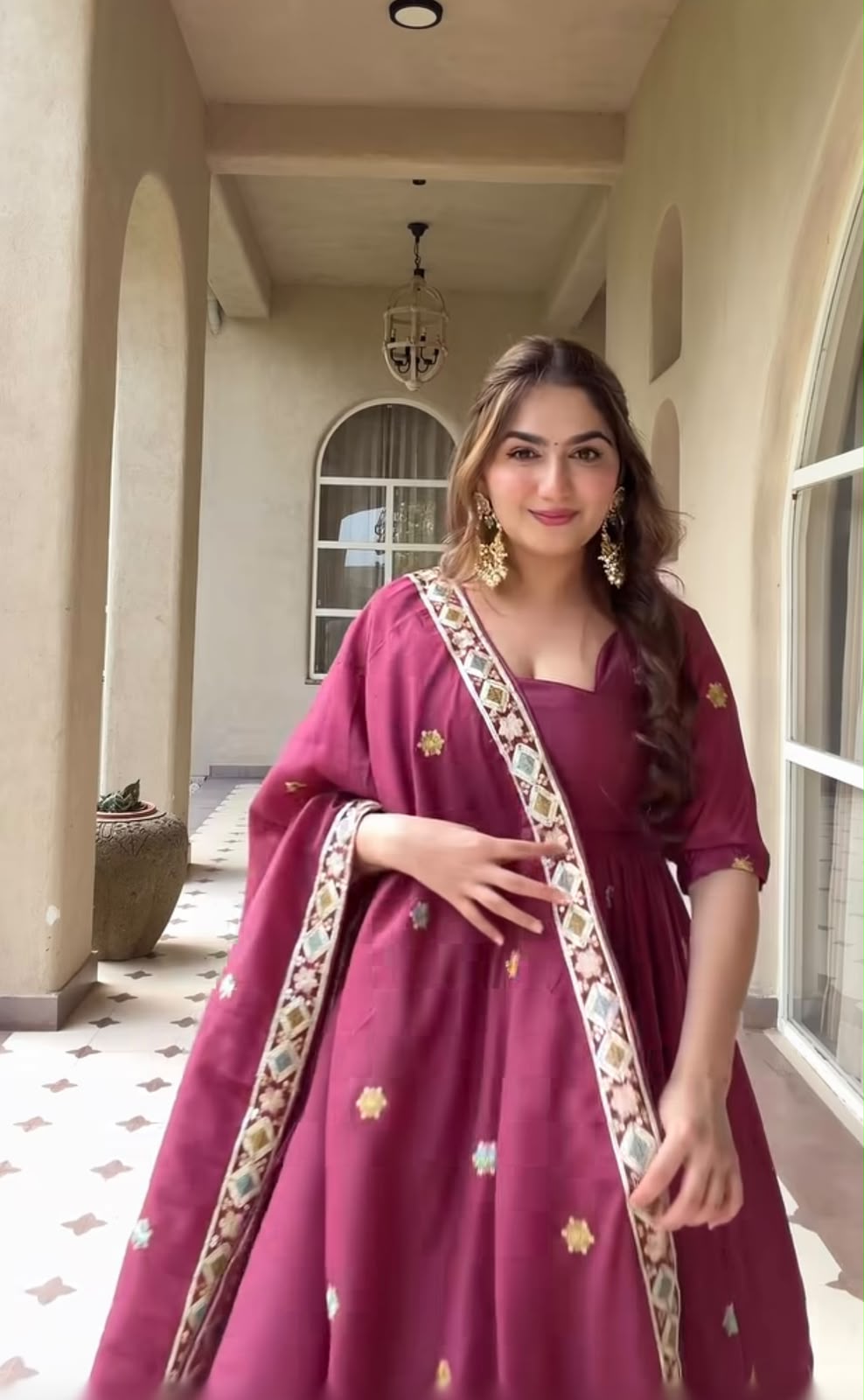 A Contemporary Interpretation of Traditional Royal Anarkali Silhouettes Against Minimalist Arched Architecture