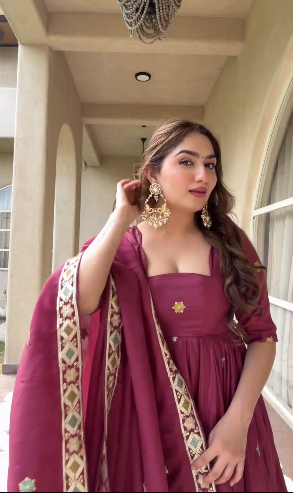 A Contemporary Interpretation of Traditional Royal Anarkali Silhouettes Against Minimalist Arched Architecture