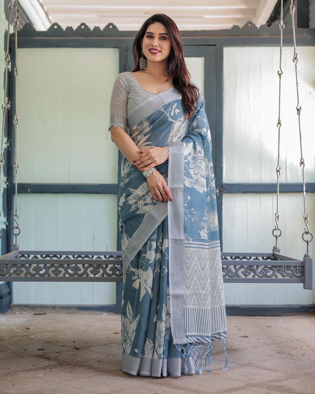 Elegant Slate Blue Mulmul Cotton Saree featuring Large Ivory Floral Block Prints, Geometric Pallu Details, and a Coordinating Textured Silver-Gray Blouse