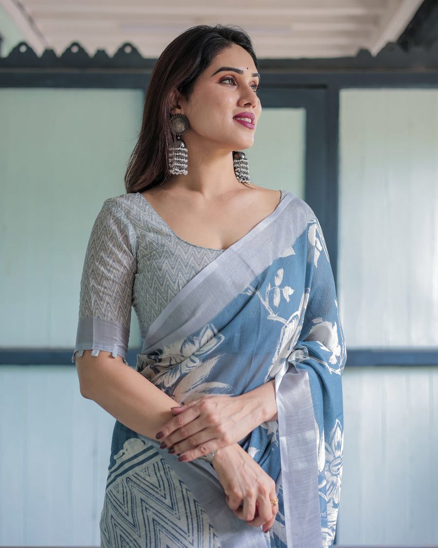 Elegant Slate Blue Mulmul Cotton Saree featuring Large Ivory Floral Block Prints, Geometric Pallu Details, and a Coordinating Textured Silver-Gray Blouse