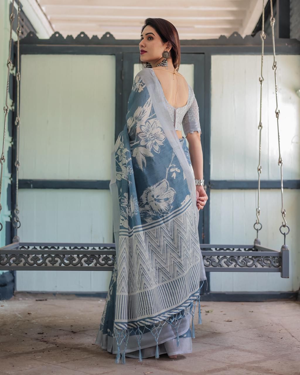 Elegant Slate Blue Mulmul Cotton Saree featuring Large Ivory Floral Block Prints, Geometric Pallu Details, and a Coordinating Textured Silver-Gray Blouse