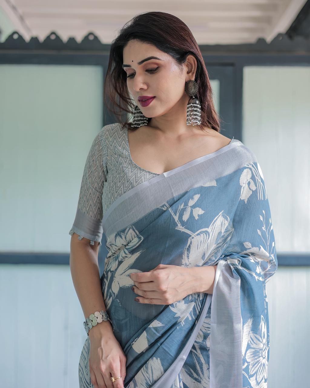 Elegant Slate Blue Mulmul Cotton Saree featuring Large Ivory Floral Block Prints, Geometric Pallu Details, and a Coordinating Textured Silver-Gray Blouse