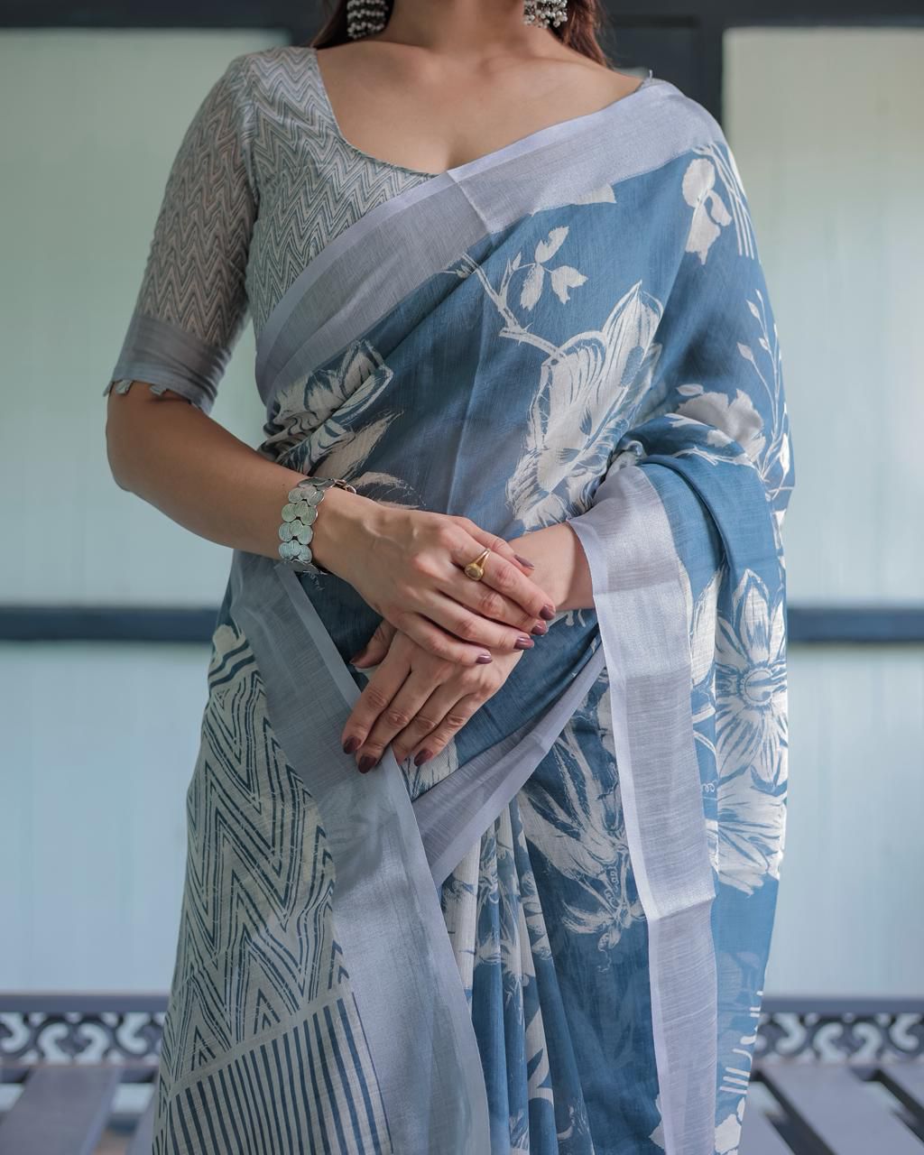 Elegant Slate Blue Mulmul Cotton Saree featuring Large Ivory Floral Block Prints, Geometric Pallu Details, and a Coordinating Textured Silver-Gray Blouse