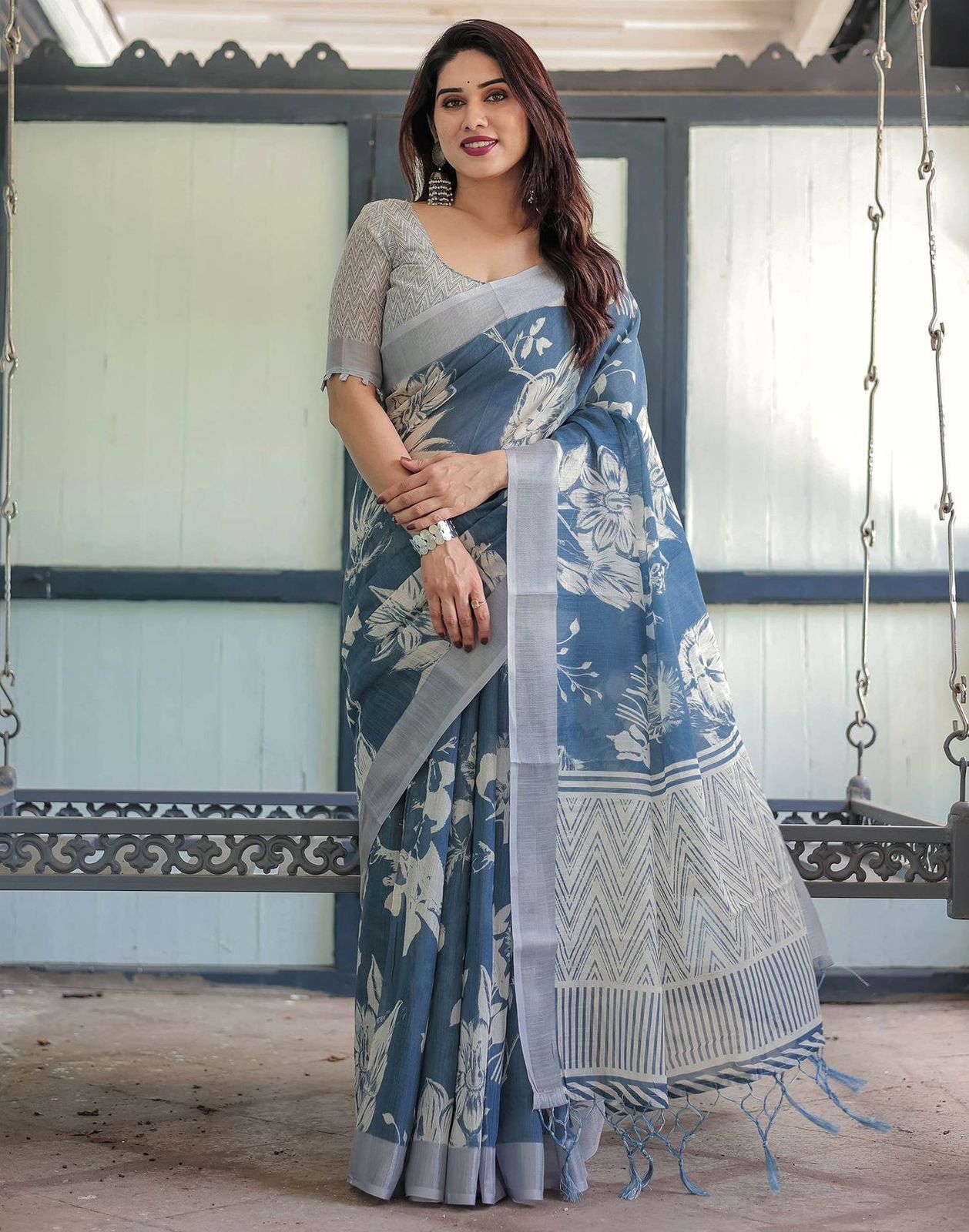 Elegant Slate Blue Mulmul Cotton Saree featuring Large Ivory Floral Block Prints, Geometric Pallu Details, and a Coordinating Textured Silver-Gray Blouse