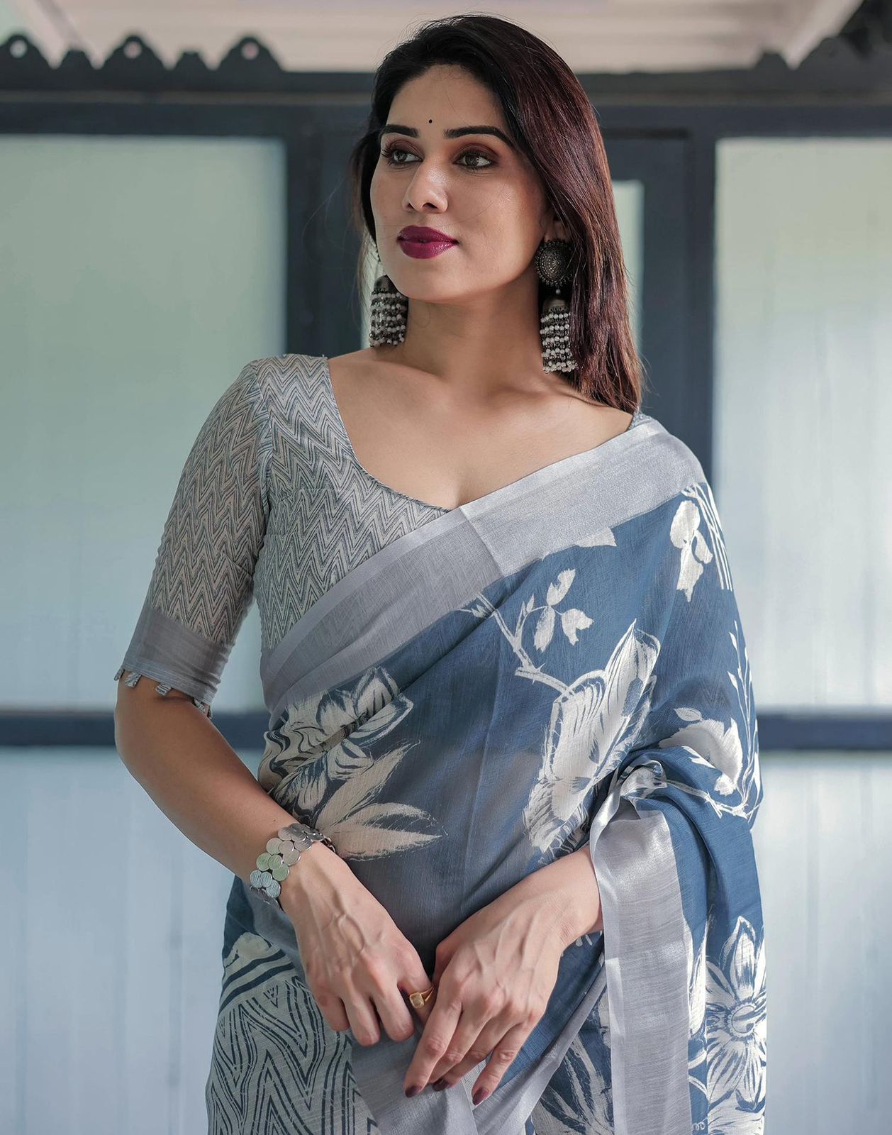 Elegant Slate Blue Mulmul Cotton Saree featuring Large Ivory Floral Block Prints, Geometric Pallu Details, and a Coordinating Textured Silver-Gray Blouse