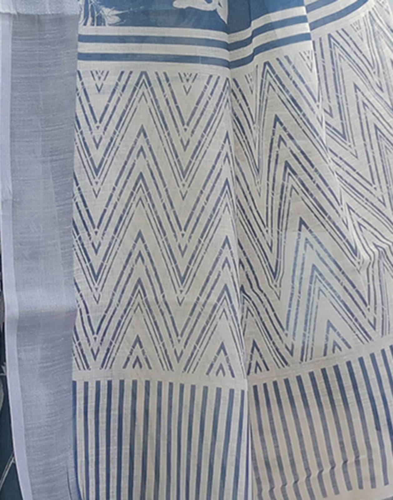 Elegant Slate Blue Mulmul Cotton Saree featuring Large Ivory Floral Block Prints, Geometric Pallu Details, and a Coordinating Textured Silver-Gray Blouse