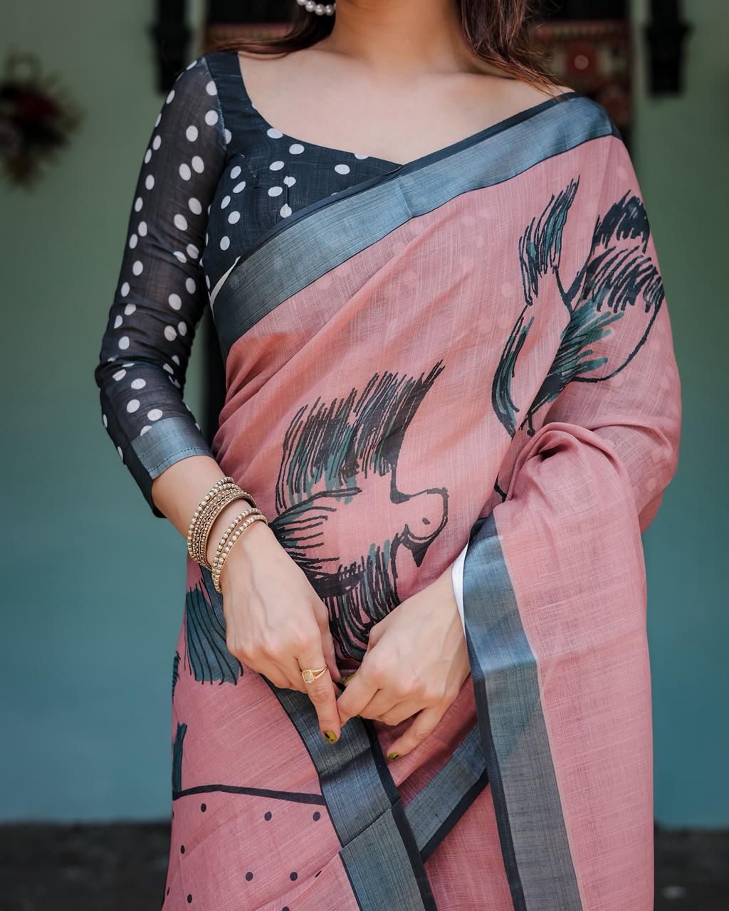 Artistic Salmon Pink Cotton Linen Saree featuring Charcoal Black Bird Sketch Illustrations, a Solid Slate Gray Border, and a Matching Polka-Dotted Blouse