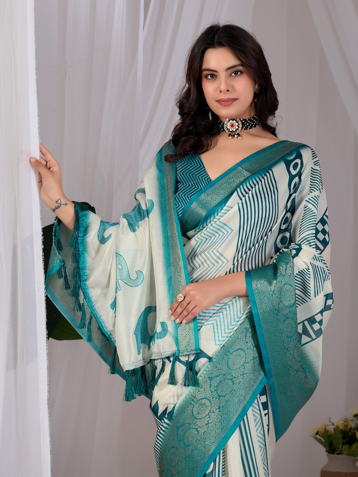 Luxury Off-White Art Silk Saree with Teal Geometric Patterns, Elephant Prints, and Zari Pallu with Tassels