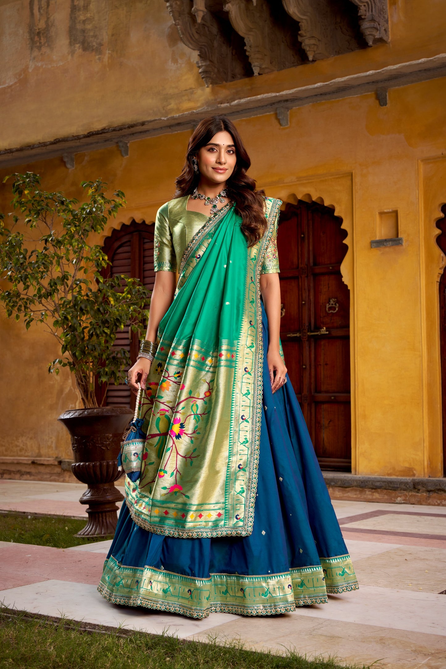 Draped in refreshing shades of green, this soft silk lehenga choli shines with intricate zari weaving, delicate sequins, thread embroidery, and an elegant scallop lace border 🍃✨