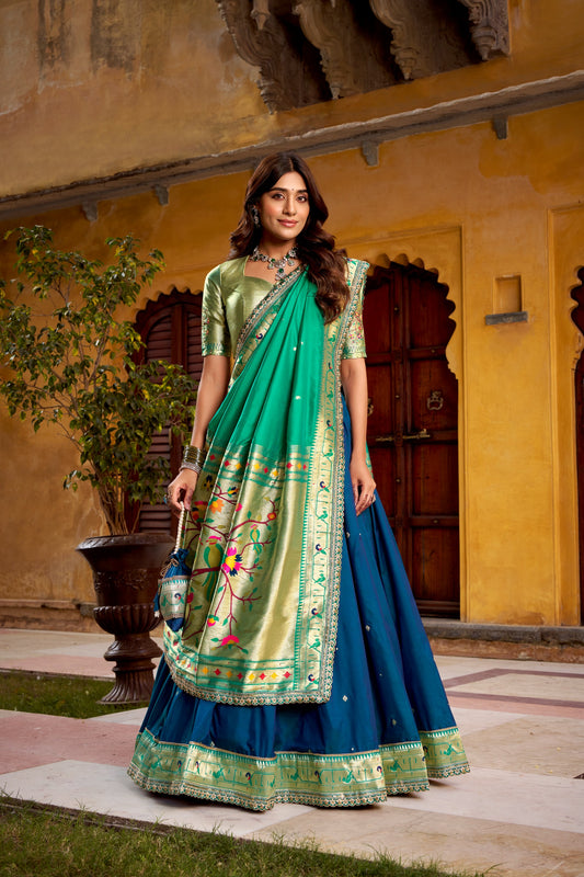 Draped in refreshing shades of green, this soft silk lehenga choli shines with intricate zari weaving, delicate sequins, thread embroidery, and an elegant scallop lace border 🍃✨