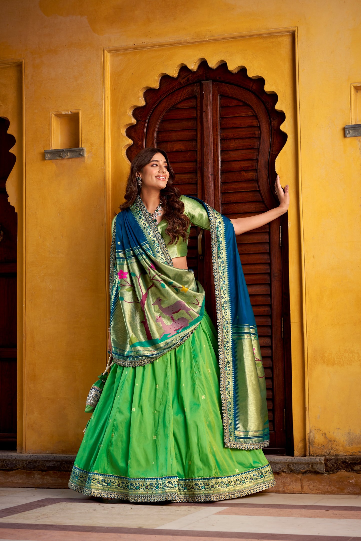 Draped in refreshing shades of green, this soft silk lehenga choli shines with intricate zari weaving, delicate sequins, thread embroidery, and an elegant scallop lace border 🍃✨