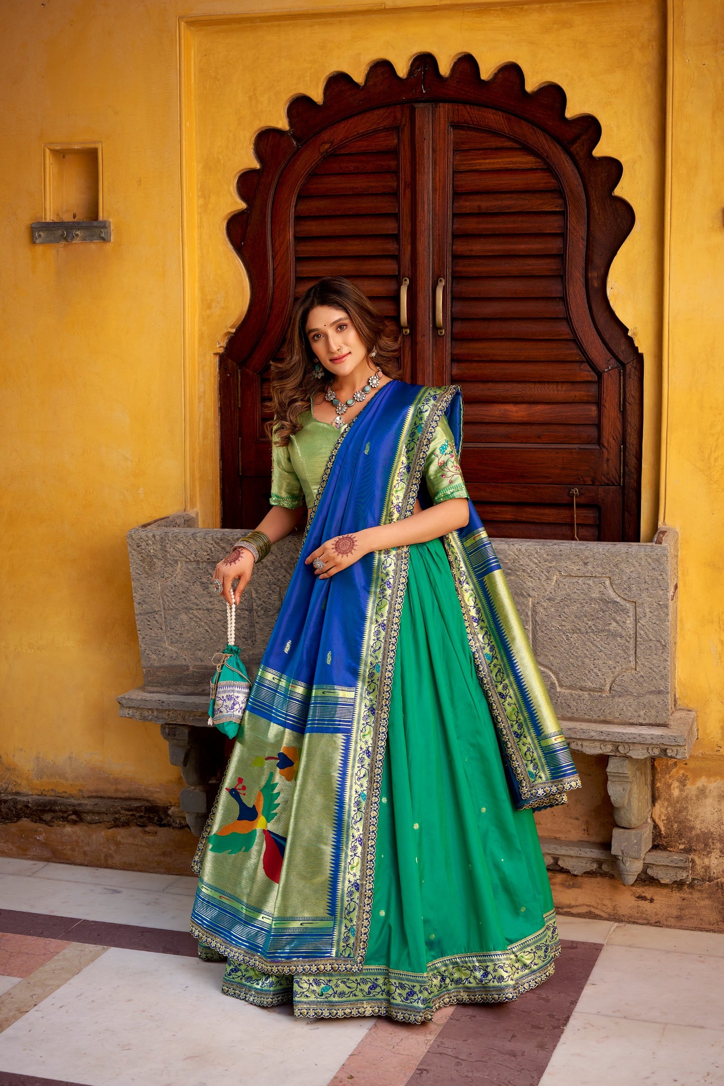 Draped in refreshing shades of green, this soft silk lehenga choli shines with intricate zari weaving, delicate sequins, thread embroidery, and an elegant scallop lace border 🍃✨