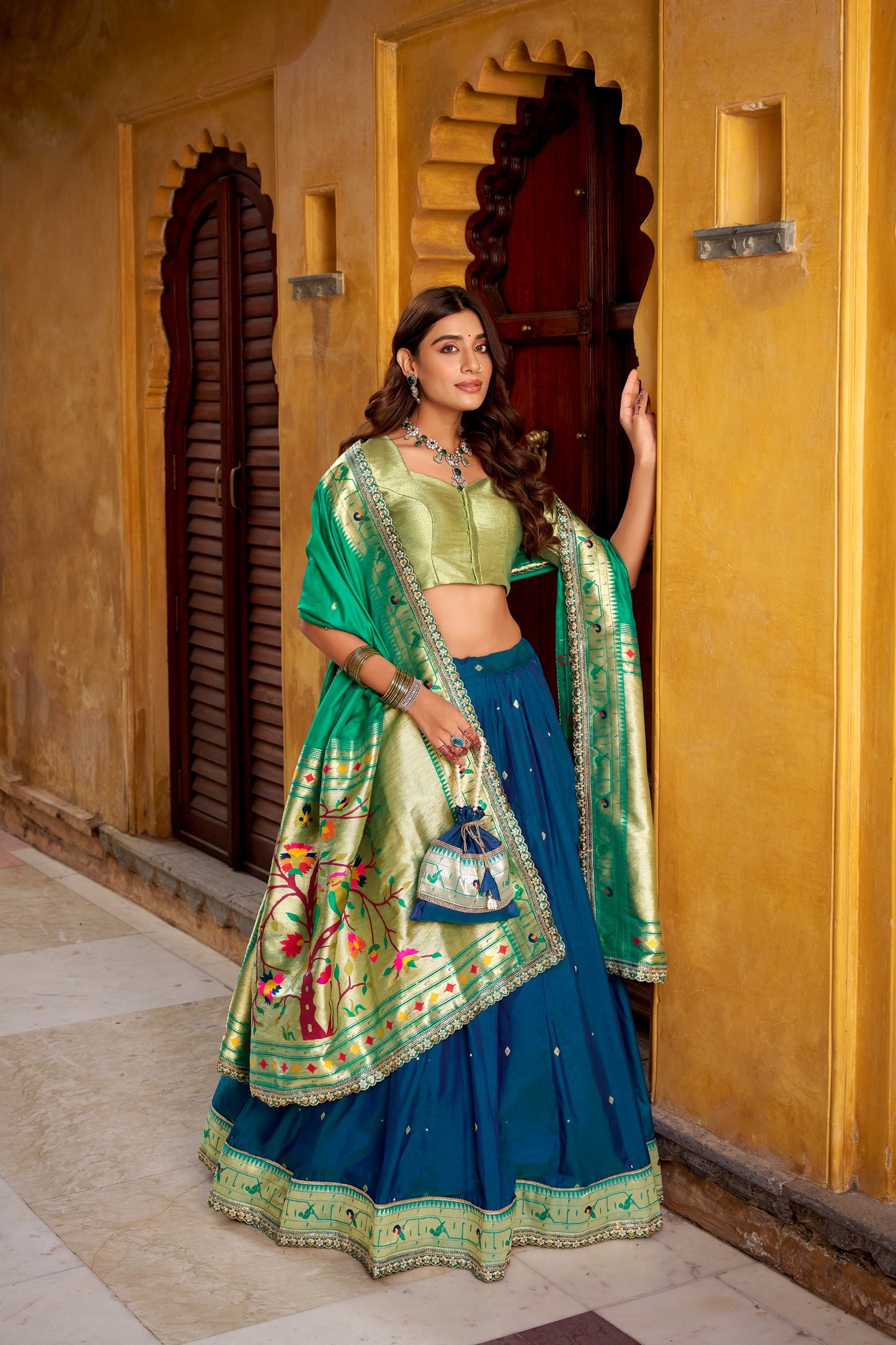 Draped in refreshing shades of green, this soft silk lehenga choli shines with intricate zari weaving, delicate sequins, thread embroidery, and an elegant scallop lace border 🍃✨