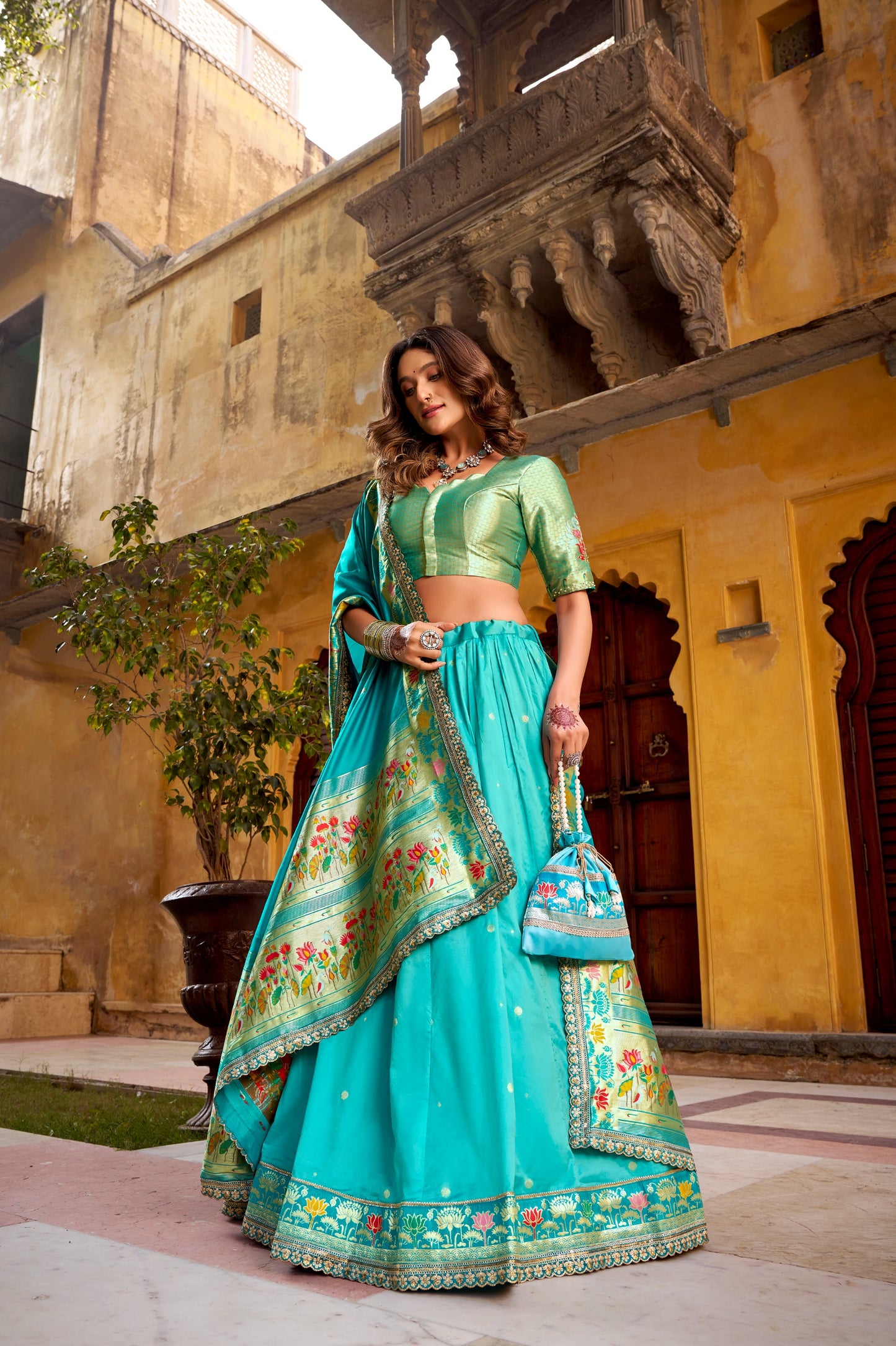 Draped in refreshing shades of green, this soft silk lehenga choli shines with intricate zari weaving, delicate sequins, thread embroidery, and an elegant scallop lace border 🍃✨