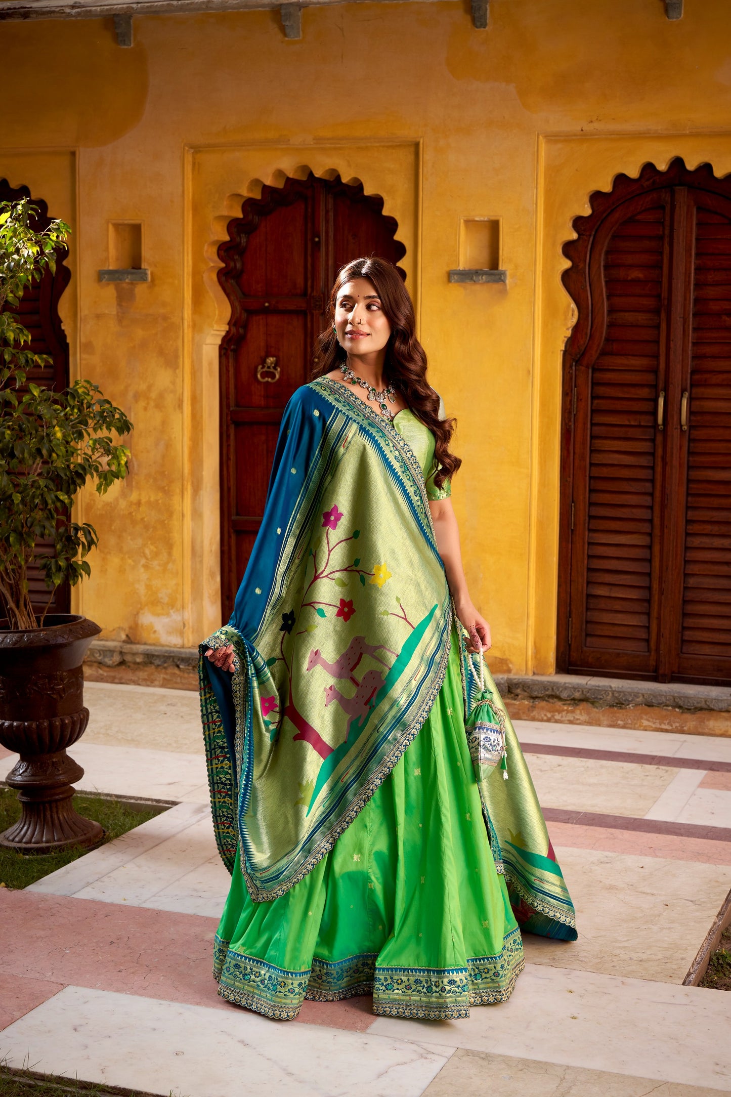 Draped in refreshing shades of green, this soft silk lehenga choli shines with intricate zari weaving, delicate sequins, thread embroidery, and an elegant scallop lace border 🍃✨