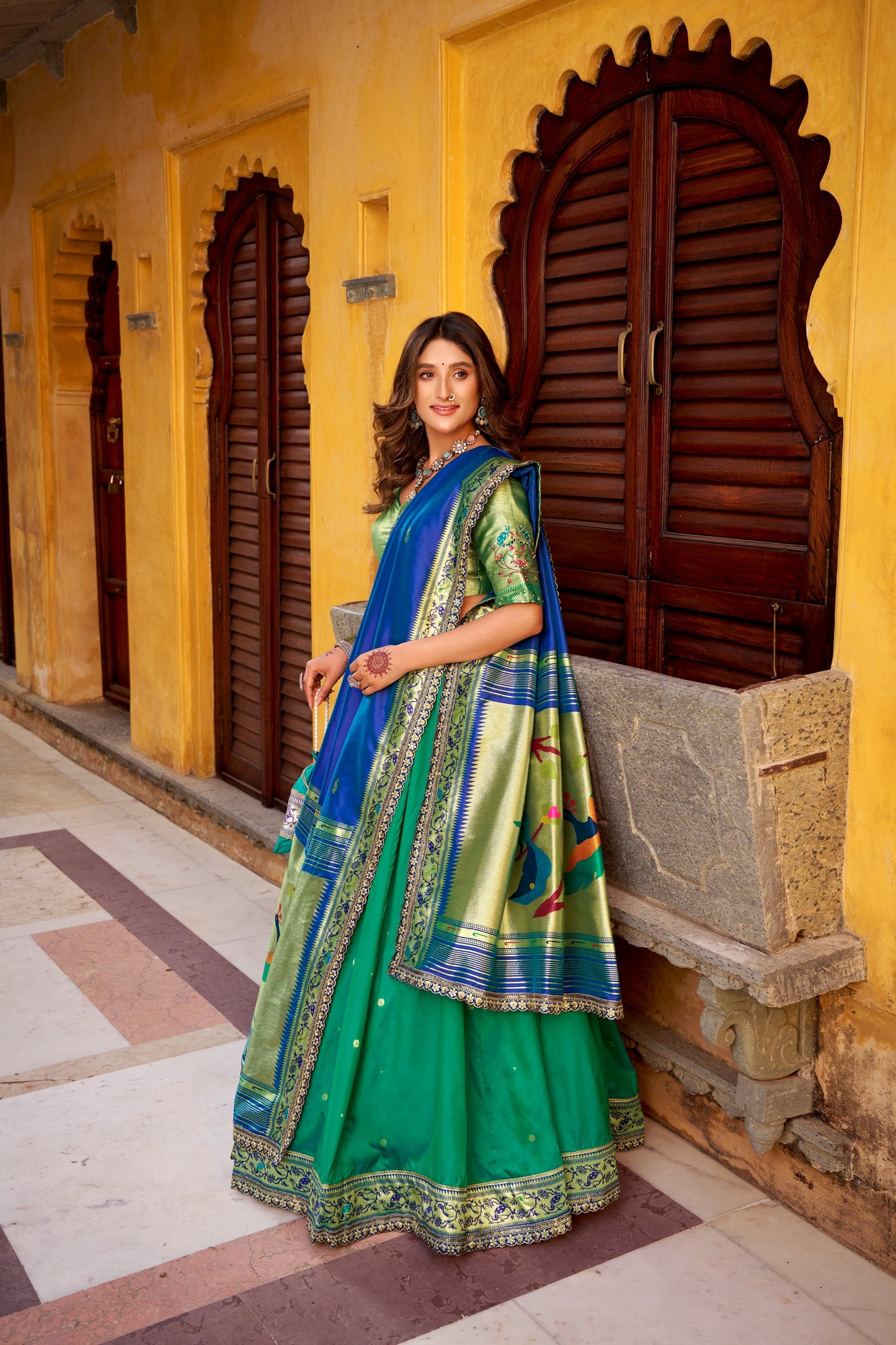 Draped in refreshing shades of green, this soft silk lehenga choli shines with intricate zari weaving, delicate sequins, thread embroidery, and an elegant scallop lace border 🍃✨