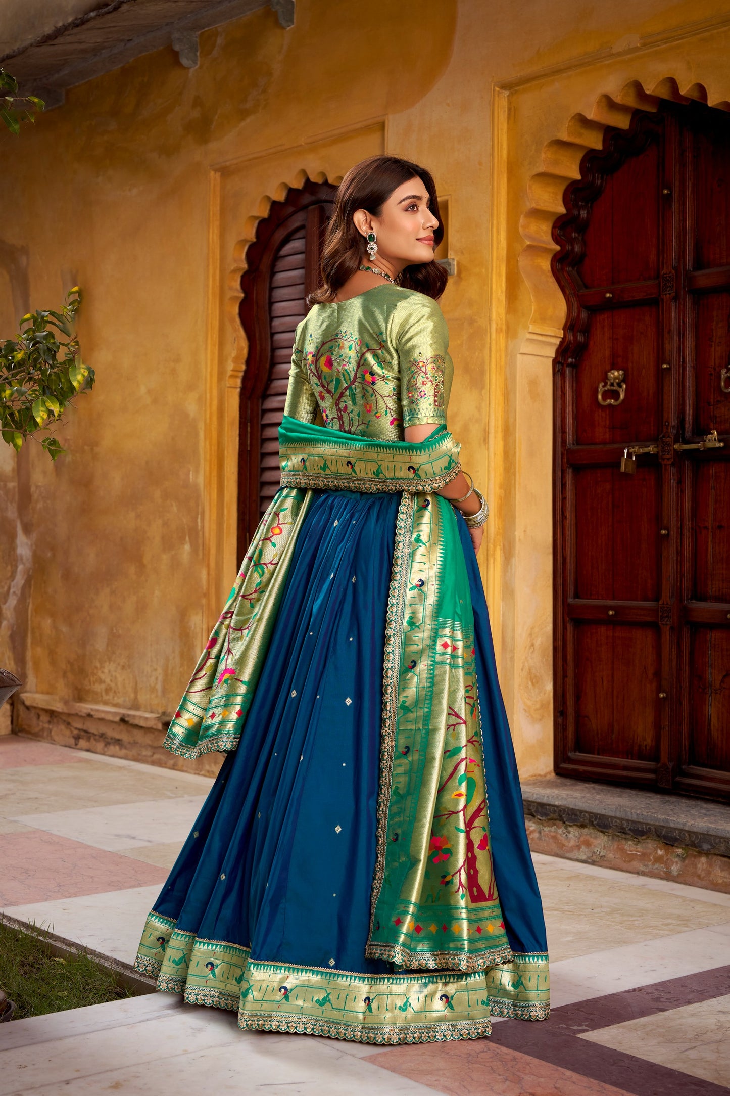 Draped in refreshing shades of green, this soft silk lehenga choli shines with intricate zari weaving, delicate sequins, thread embroidery, and an elegant scallop lace border 🍃✨