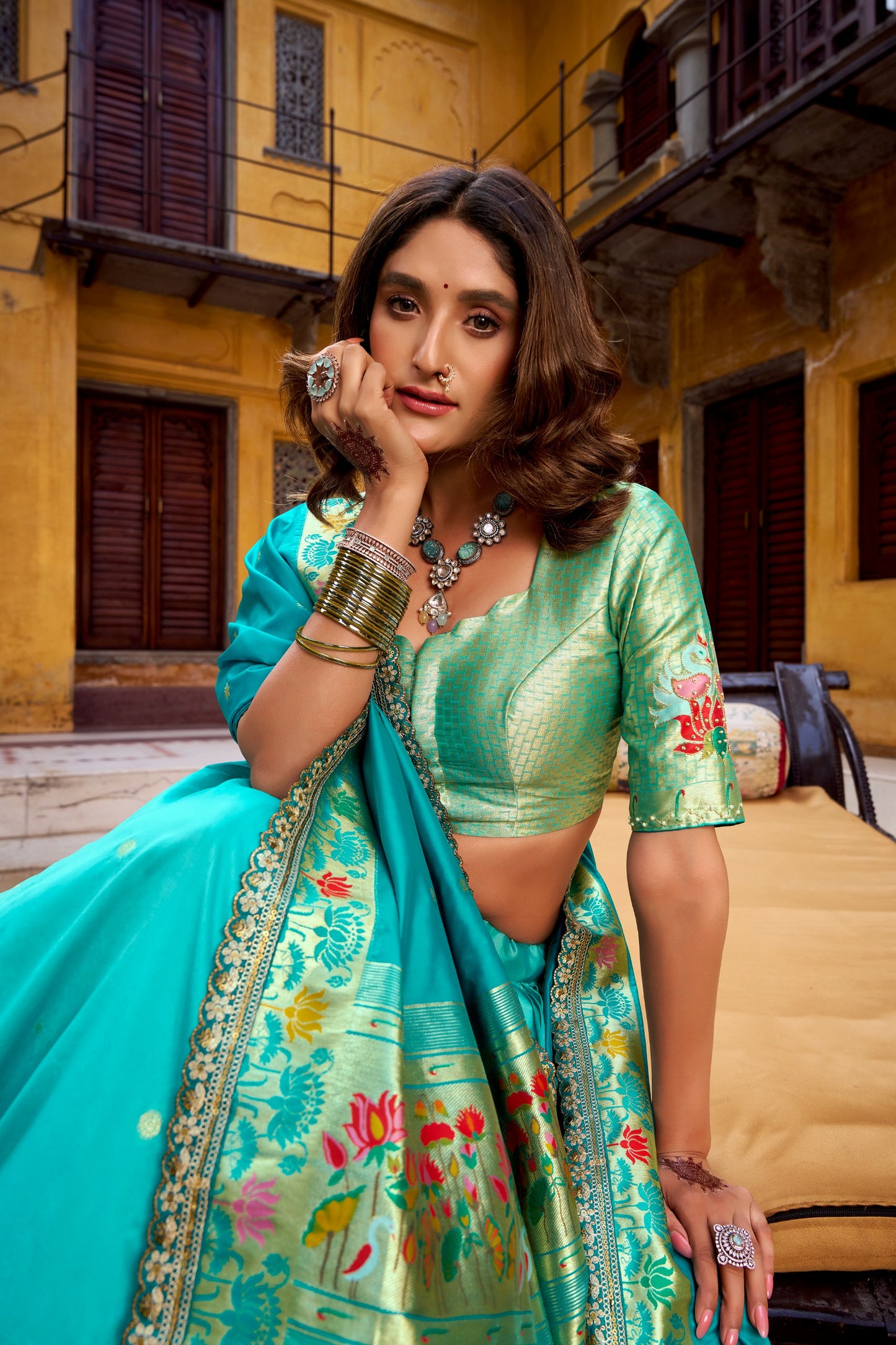 Draped in refreshing shades of green, this soft silk lehenga choli shines with intricate zari weaving, delicate sequins, thread embroidery, and an elegant scallop lace border 🍃✨