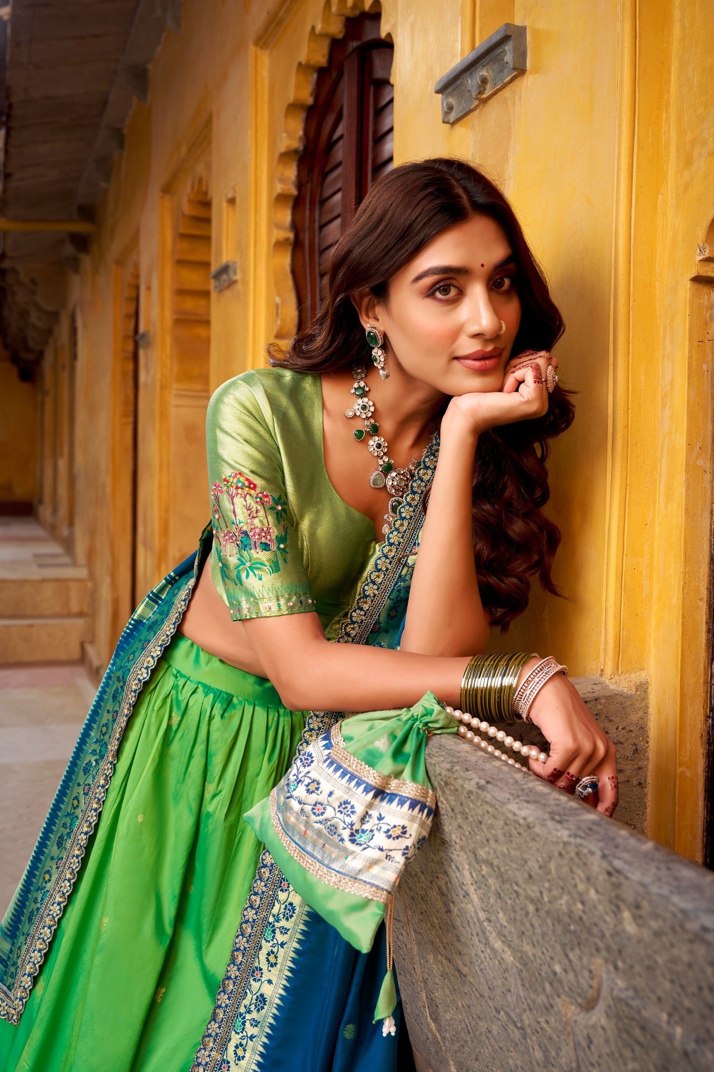Draped in refreshing shades of green, this soft silk lehenga choli shines with intricate zari weaving, delicate sequins, thread embroidery, and an elegant scallop lace border 🍃✨