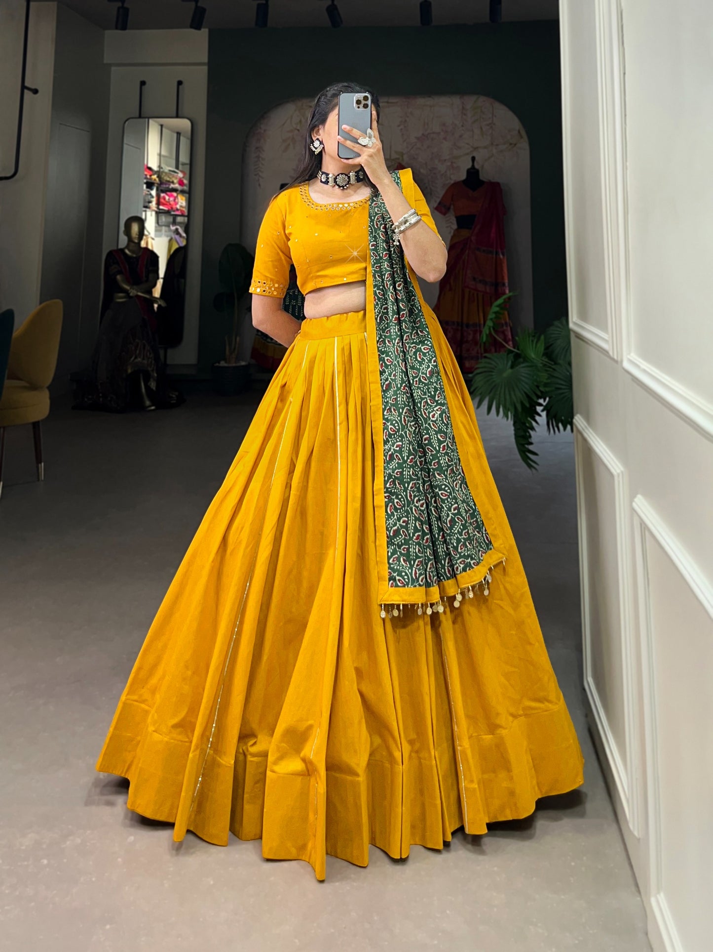 Dance through Navratri nights in this beautifully printed pure cotton lehenga choli. Complete with a matching purse and intricate coin lace detailing, it's perfect for the celebrations! 🥰